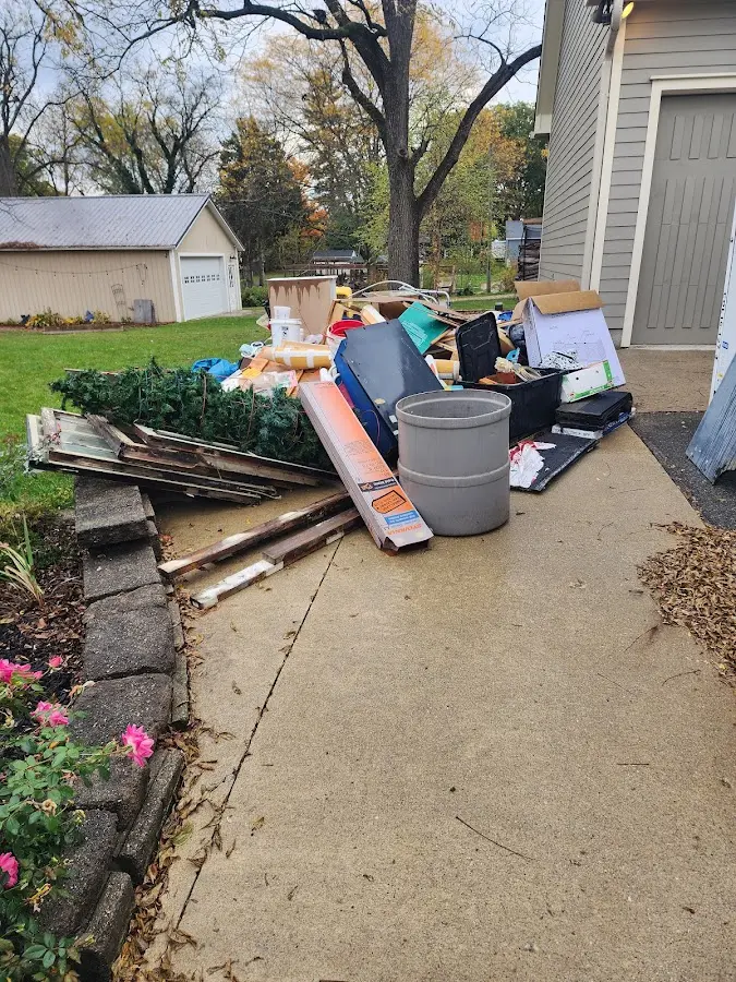 Dumpster being loaded with debris for Estate Cleanout Dumpster Rental in Coeymans
